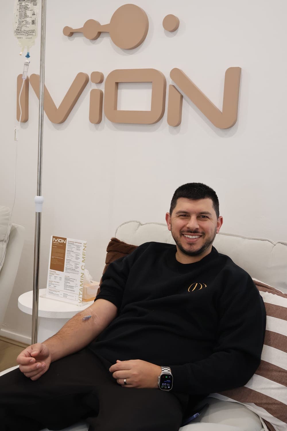 A client relaxed during his IV drip in front of the IVION Health wall in Oatlands
